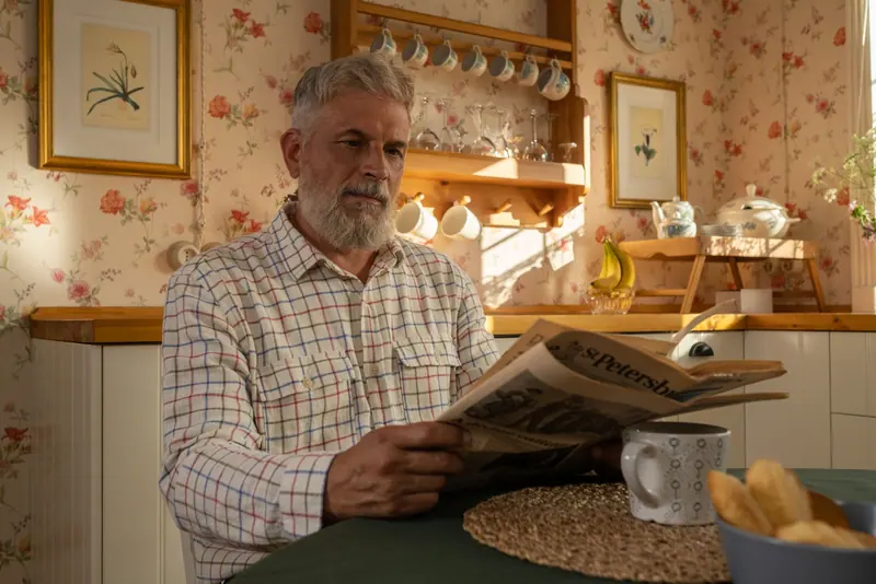 A resident reading the morning paper over breakfast
