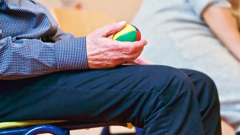 A resident working with a therapy ball