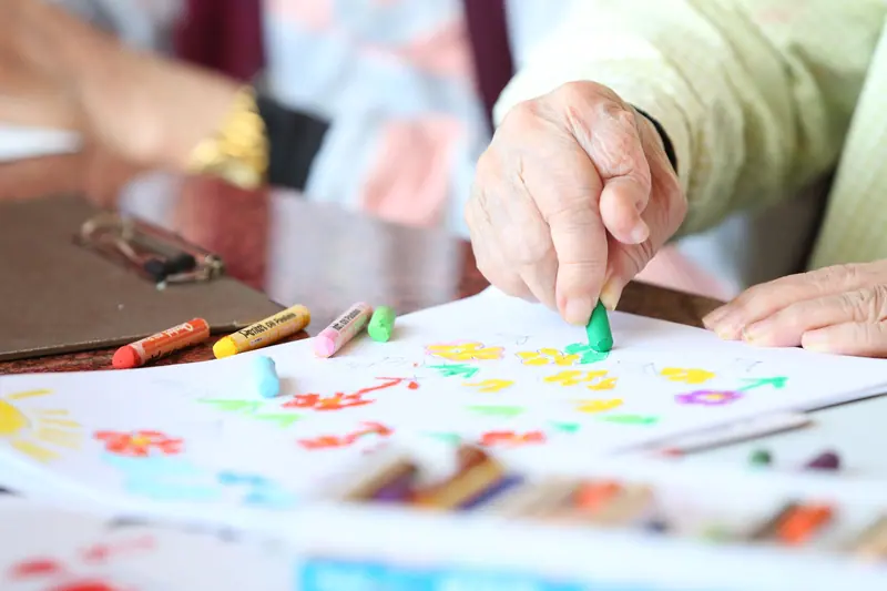 A resident drawing during art time