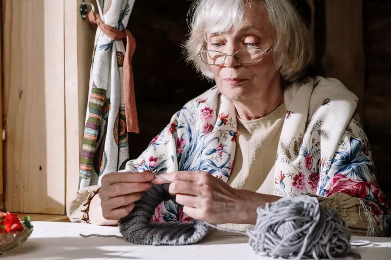 A resident knitting by the sunny window