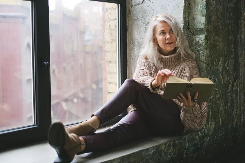A resident reading on the deep window seat