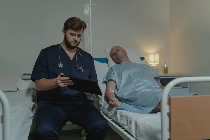 A nurse going over the day's plan with a patient in bed