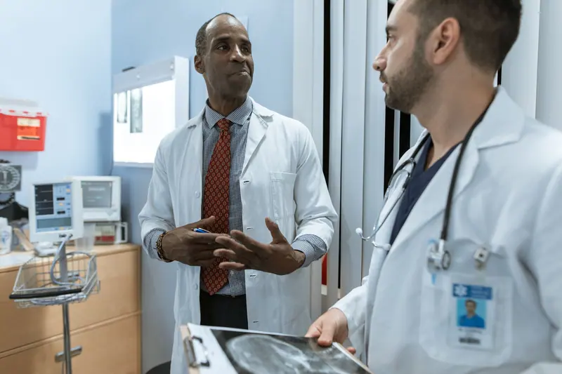 Two physicians conferring on the hall