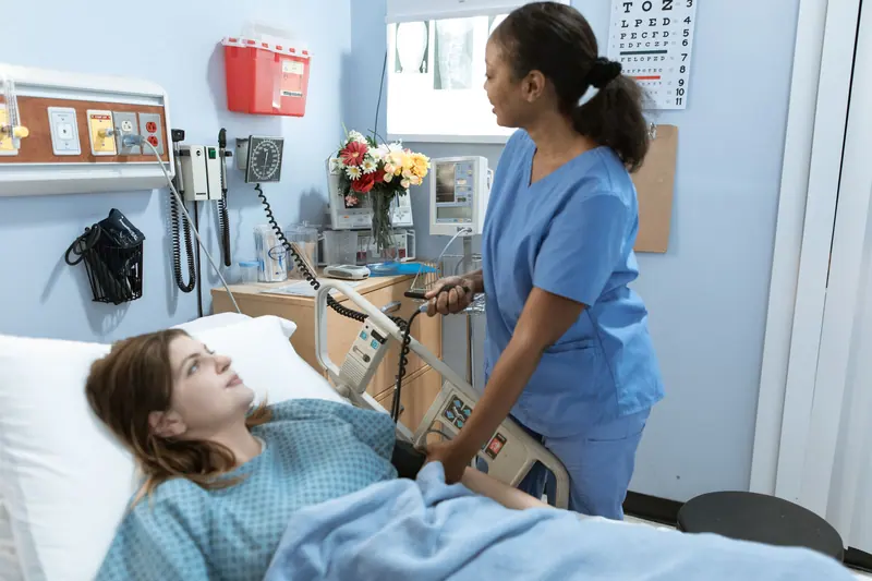 A nurse adjusting a resident's pillow