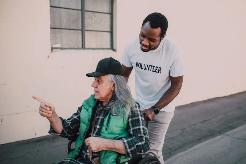 A volunteer and a resident sharing a joke outside