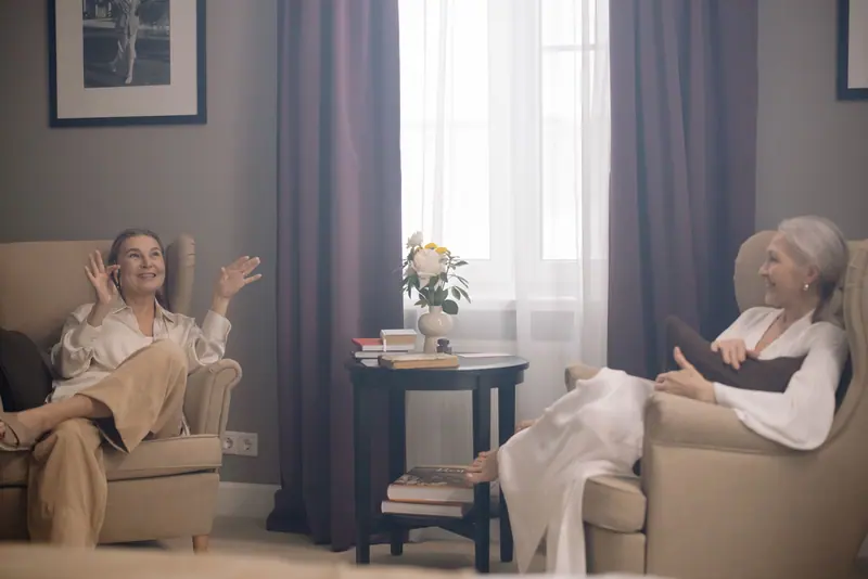 Two patients chatting in the family lounge