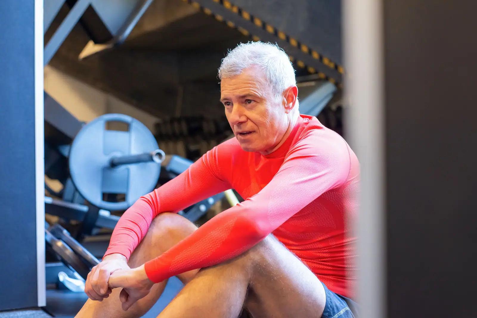 A rehab patient resting between sets in the therapy gym