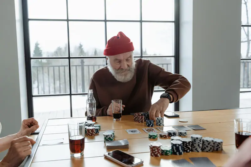 A resident in a red cap stacking chips during Friday game night