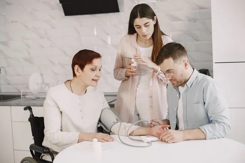 A family member helping with a blood pressure check