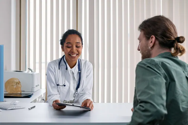 A patient going over her recovery plan with the doctor