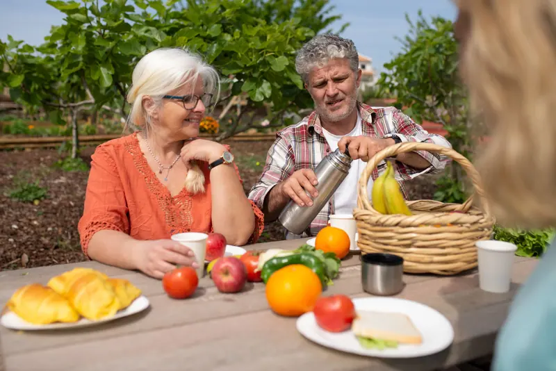 A resident couple sharing a picnic lunch in the garden