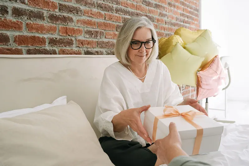 A resident opening a birthday present